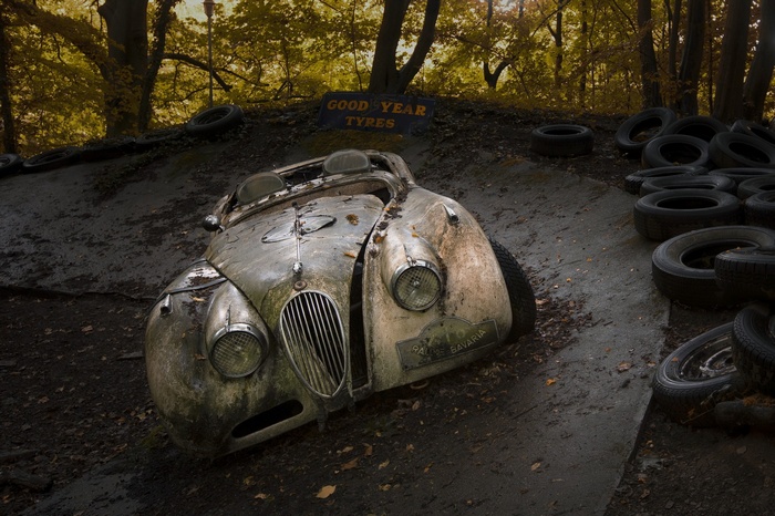 Abandoned vintage car with Goodyear Tyres sign