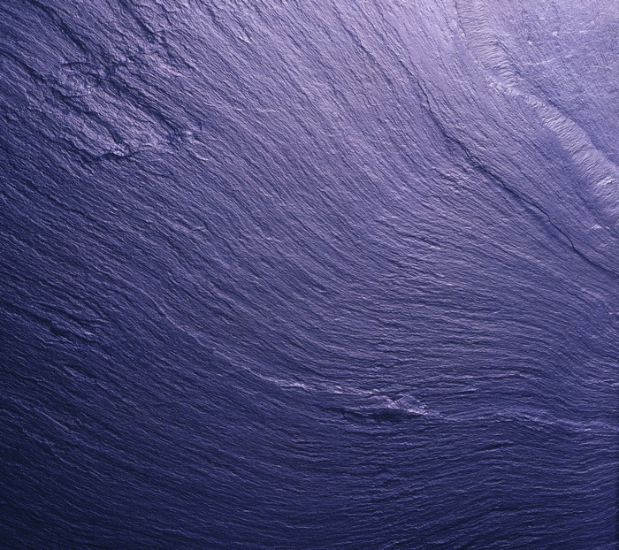 Abstract purple slate texture with wavy lines