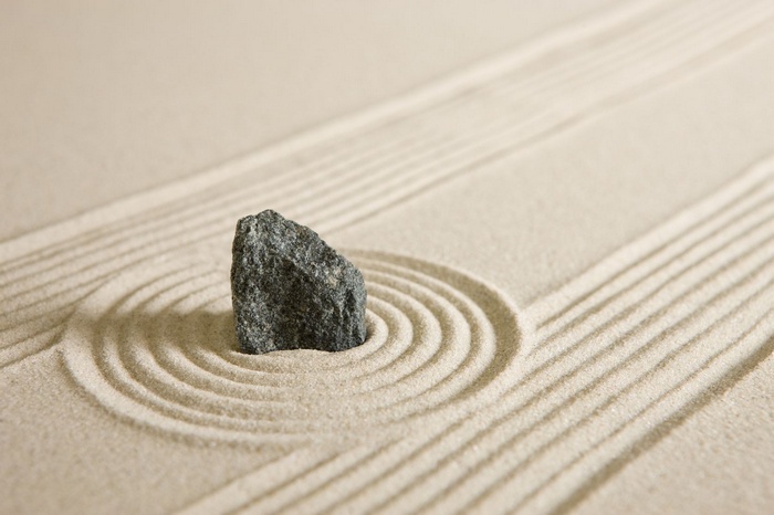 Zen garden with stone and raked sand patterns