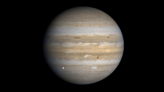 Jupiter and its moons in space