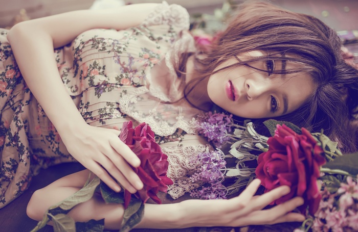 Asian woman lying down with flowers