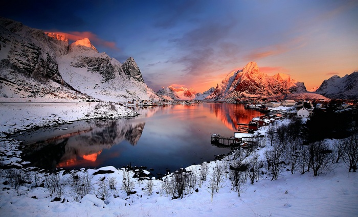 Winter landscape in Norway with snow-covered mountains and a lake