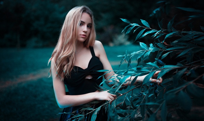 Woman in black dress among plants
