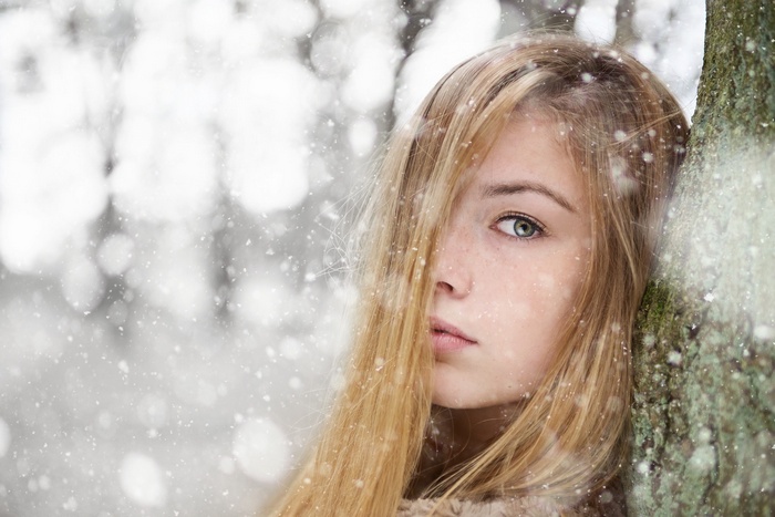 Young woman with blonde hair in the snow