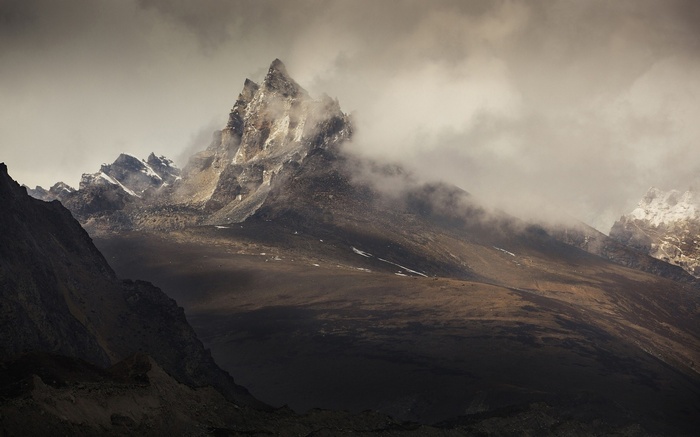 Jagged mountain peaks shrouded in clouds