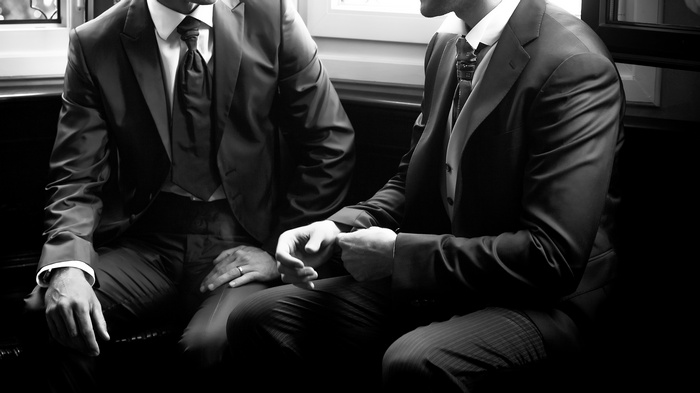 Two men in suits sitting together