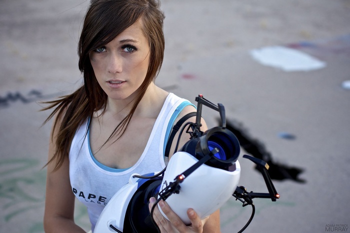 Cosplayer holding a Portal Gun from Aperture Laboratories