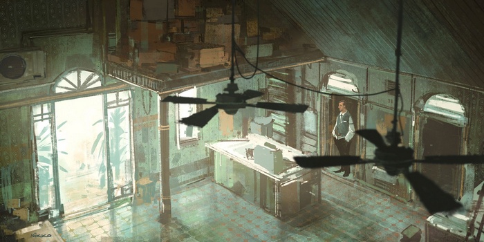 Man standing in a cluttered, vintage interior with ceiling fans.