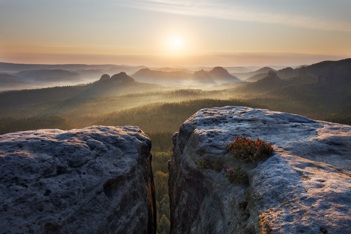 Misty mountains at sunrise in Germany with rock formations