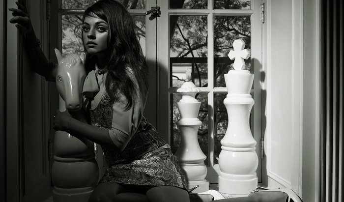 Mila Kunis with Chess Pieces and Toy Horse