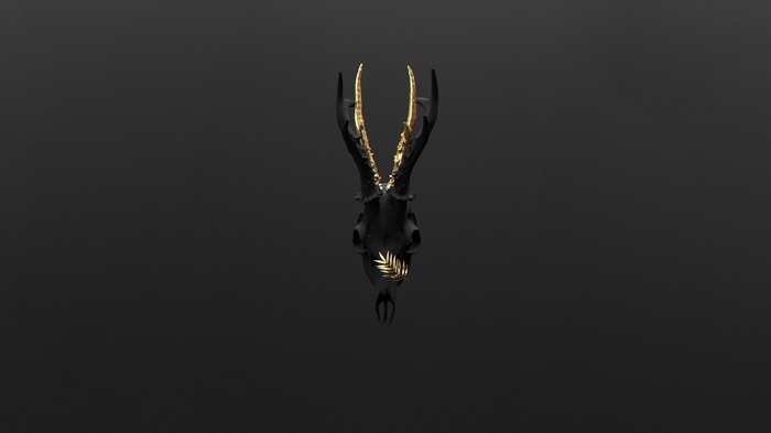 Black deer skull with gold antlers and leaf