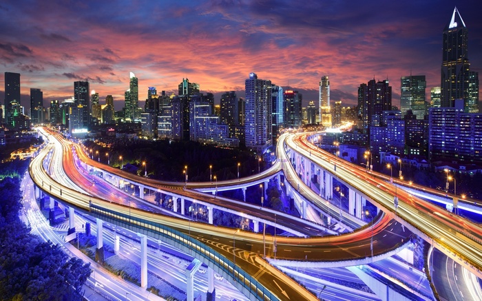 Shanghai cityscape with highway interchange at dusk