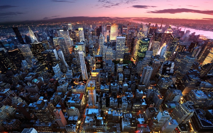 New York City skyscrapers at dusk with city lights