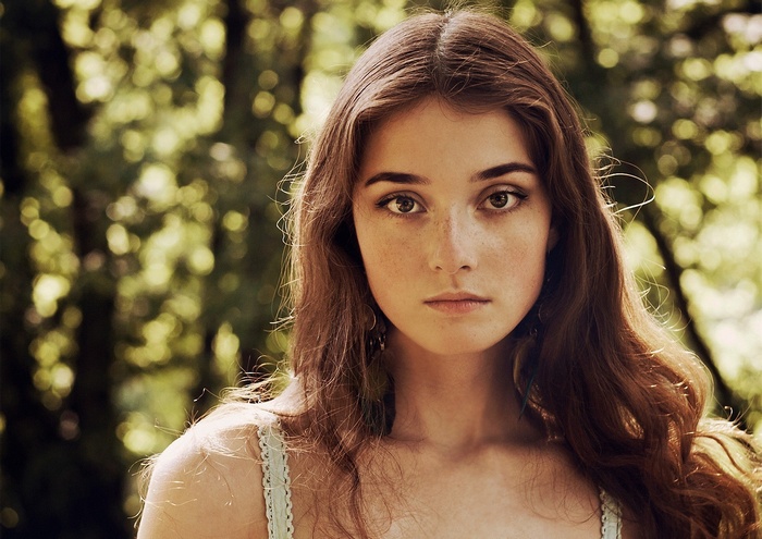 Portrait of a young woman with freckles