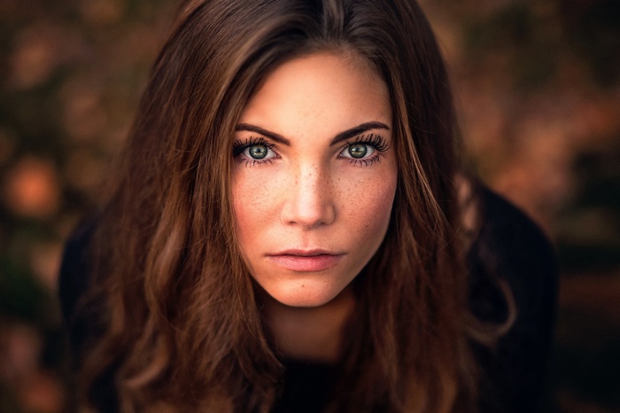 Portrait of a woman with freckles and green eyes