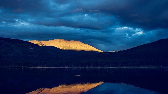 Mountain range reflected in a lake at dusk