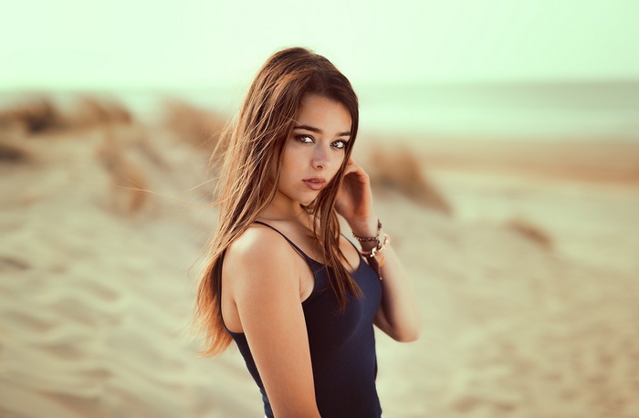Woman posing on a sandy beach