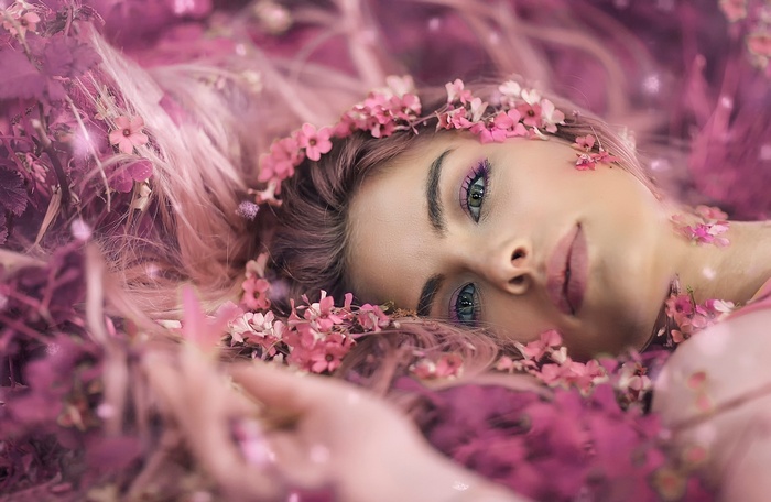 music, face, closeup, looking at viewer, long hair, Alessandro Di Cicco, portrait, makeup, flowers, model, brunette, lips, women, petals, flower in hair, flower petals, pink flowers, lying on back, lying down, depth of field