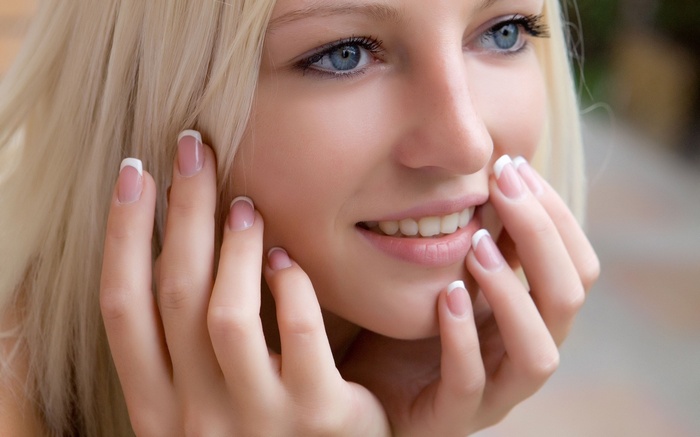 Alysha A with blonde hair and blue eyes smiling