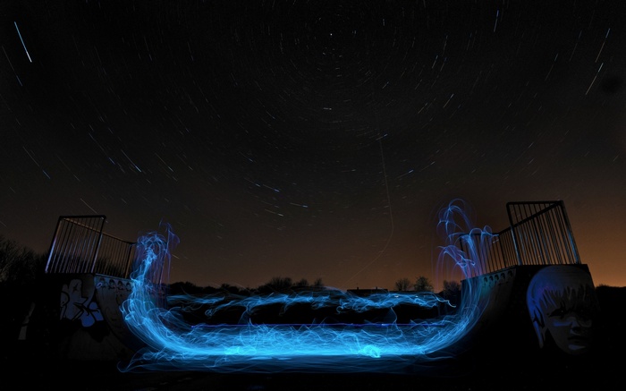 Long exposure light painting at a skatepark under the stars