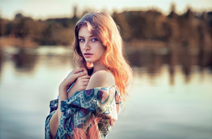 Woman with long wavy hair by the water