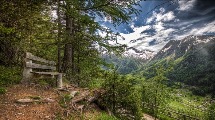 Bench overlooking a valley in the Swiss Alps