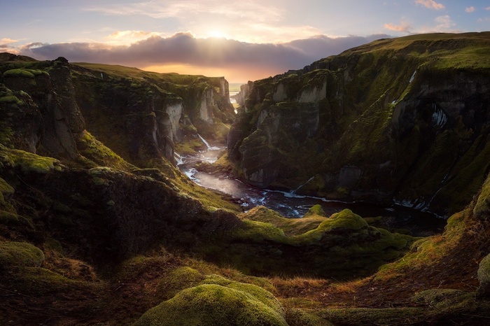 Sunset over a moss-covered canyon with a river in Iceland
