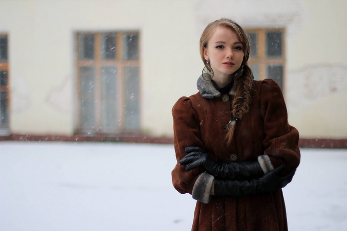 Olesya Kharitonova in a brown coat outdoors in snow