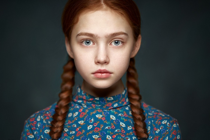 Young redhead girl with pigtails