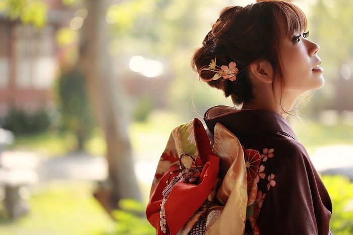 Woman in traditional Japanese kimono with floral hair accessory
