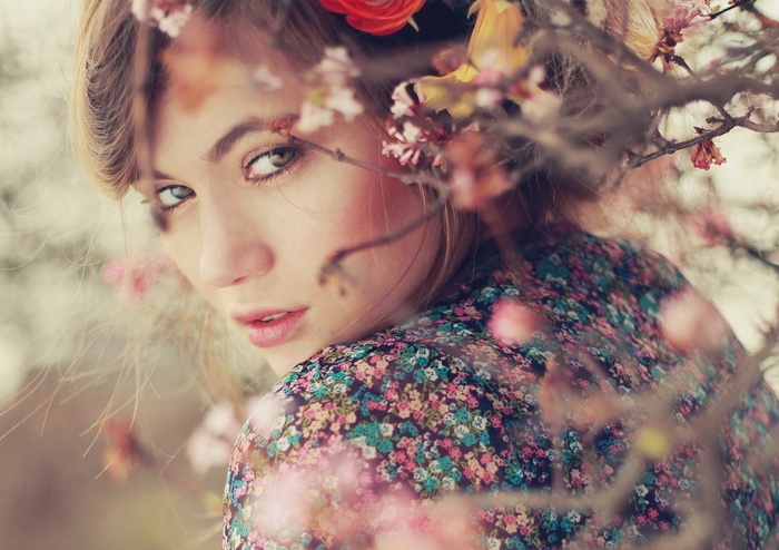 Woman with flowers in her hair and floral shirt