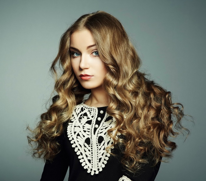 Portrait of a young woman with long curly hair