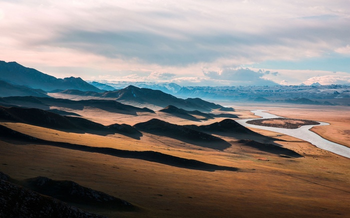 River flowing through a vast mountain landscape