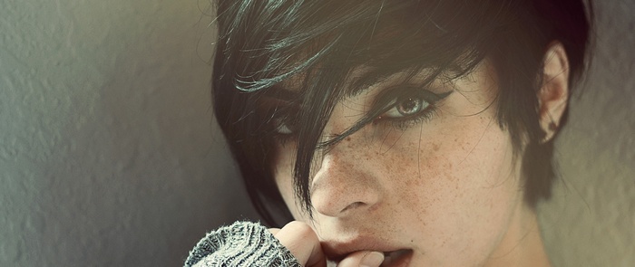 Woman with short dark hair and freckles