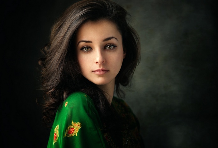 Portrait of a woman with dark hair and green scarf