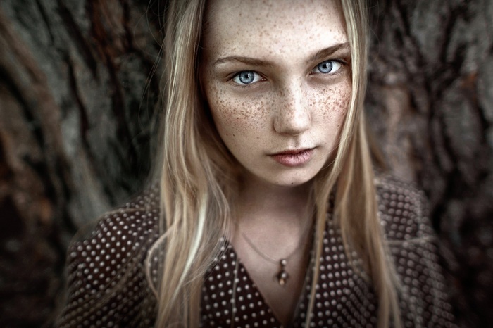 Portrait of a young woman with freckles