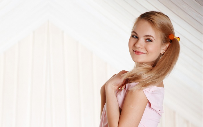 Talia Cherry with blonde pigtails smiling