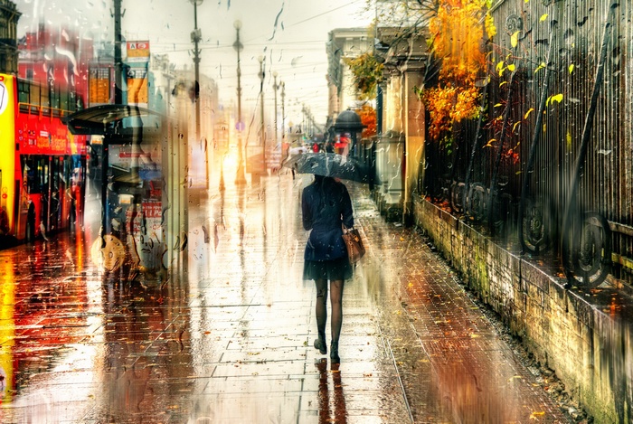 Woman with umbrella walking in rainy St. Petersburg