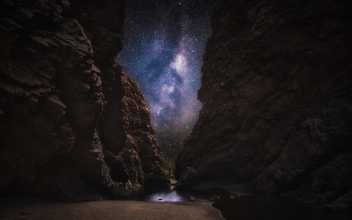 Milky Way Galaxy Over a Rocky Canyon Beach
