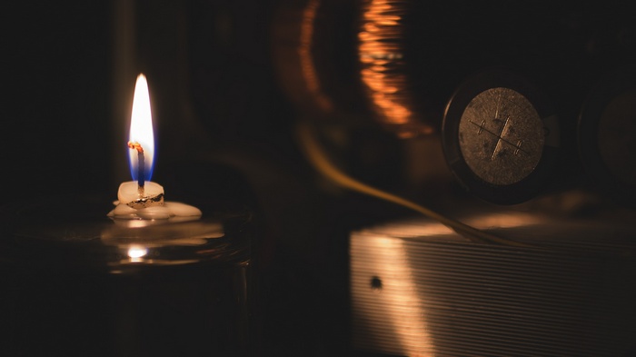 Close-up of a lit candle with melted wax