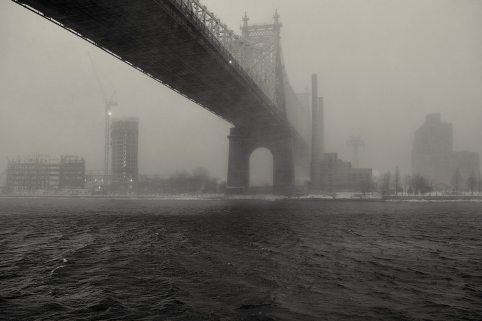 Queensboro Bridge in mist over water