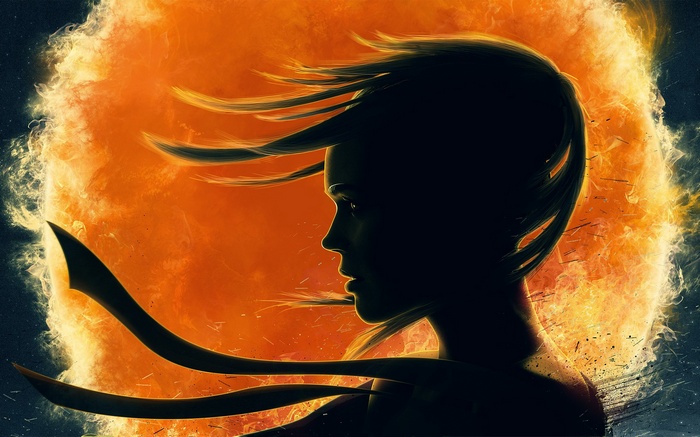 Silhouette of a woman against a fiery sun