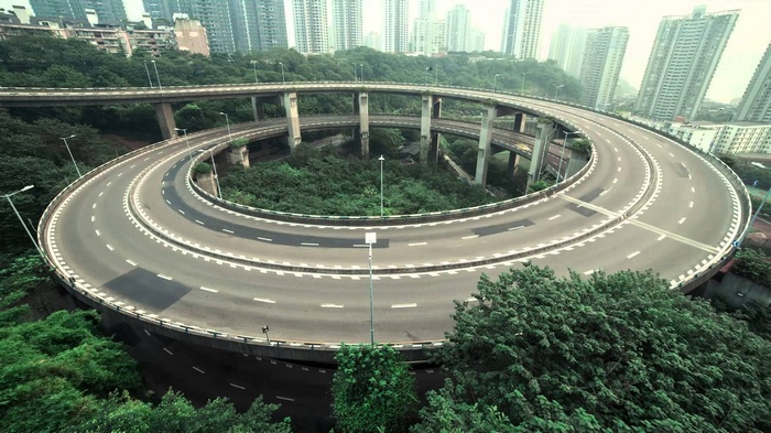 Spiral highway interchange in a Chinese city with tall buildings