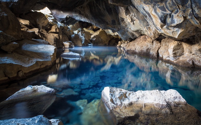 Blue lake inside a rocky cave