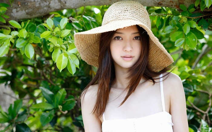 Japanese woman wearing a straw hat in nature