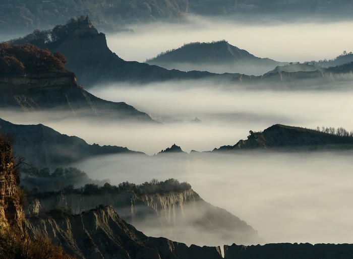 Misty mountains and cliffs at sunrise