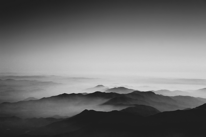 Monochrome mountain landscape with mist