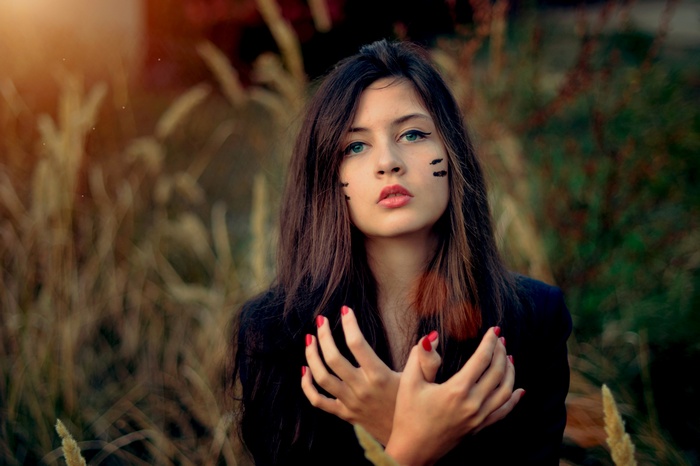 Woman with face paint in a field