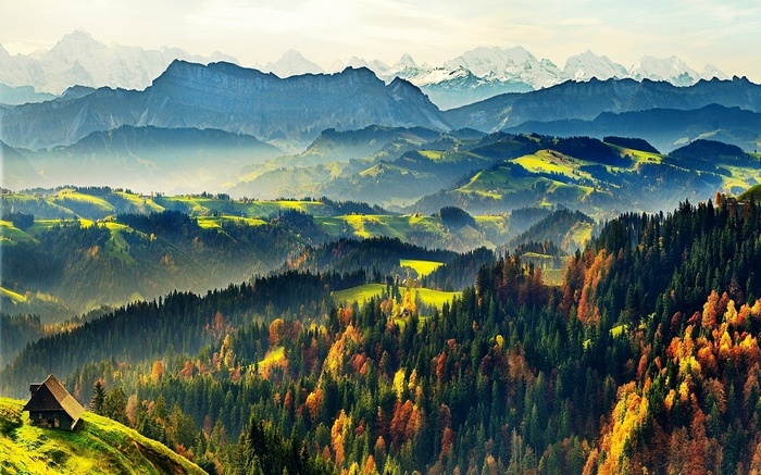 Autumnal Swiss Alps with a Cabin and Misty Mountains