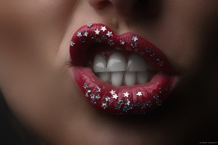 Woman with red lipstick and star glitter